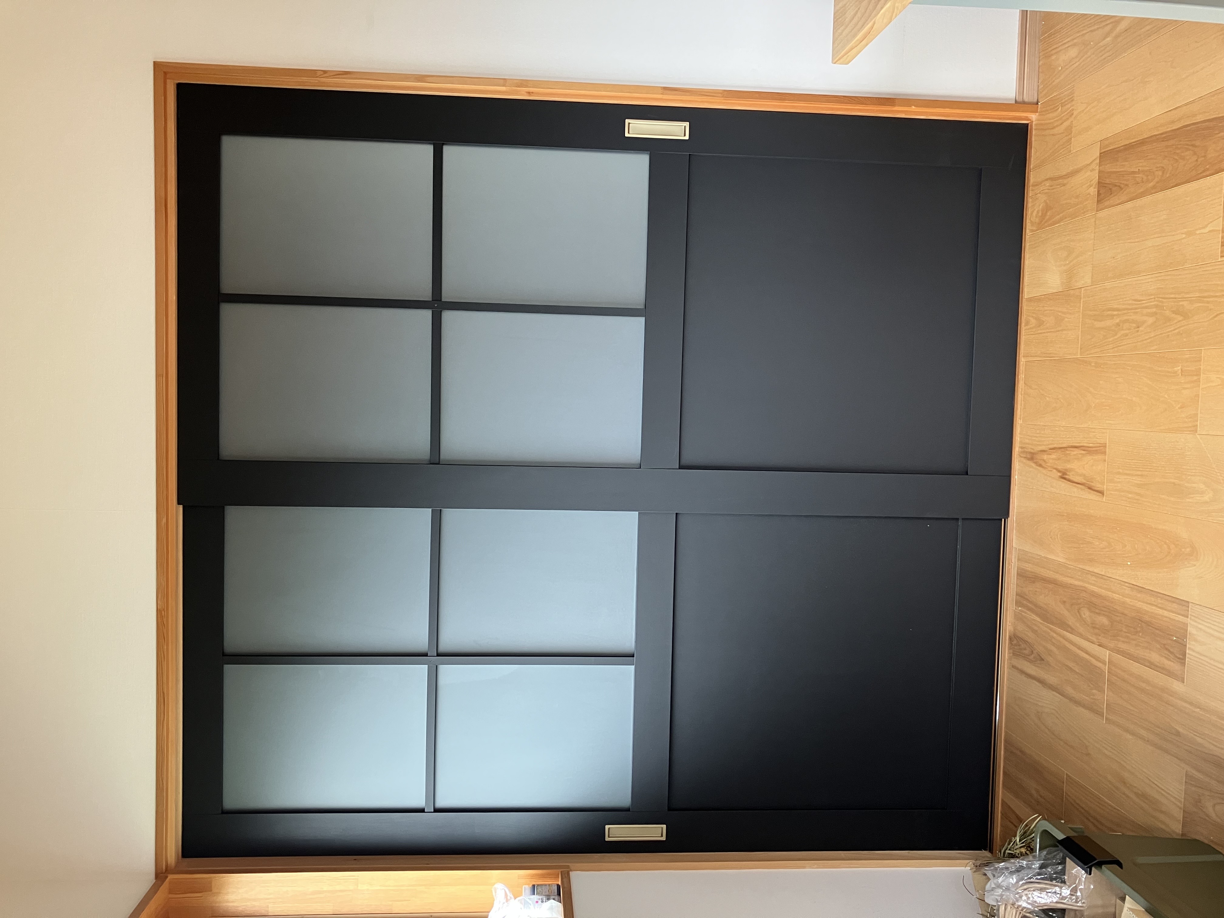 木目のタイルを貼る男性