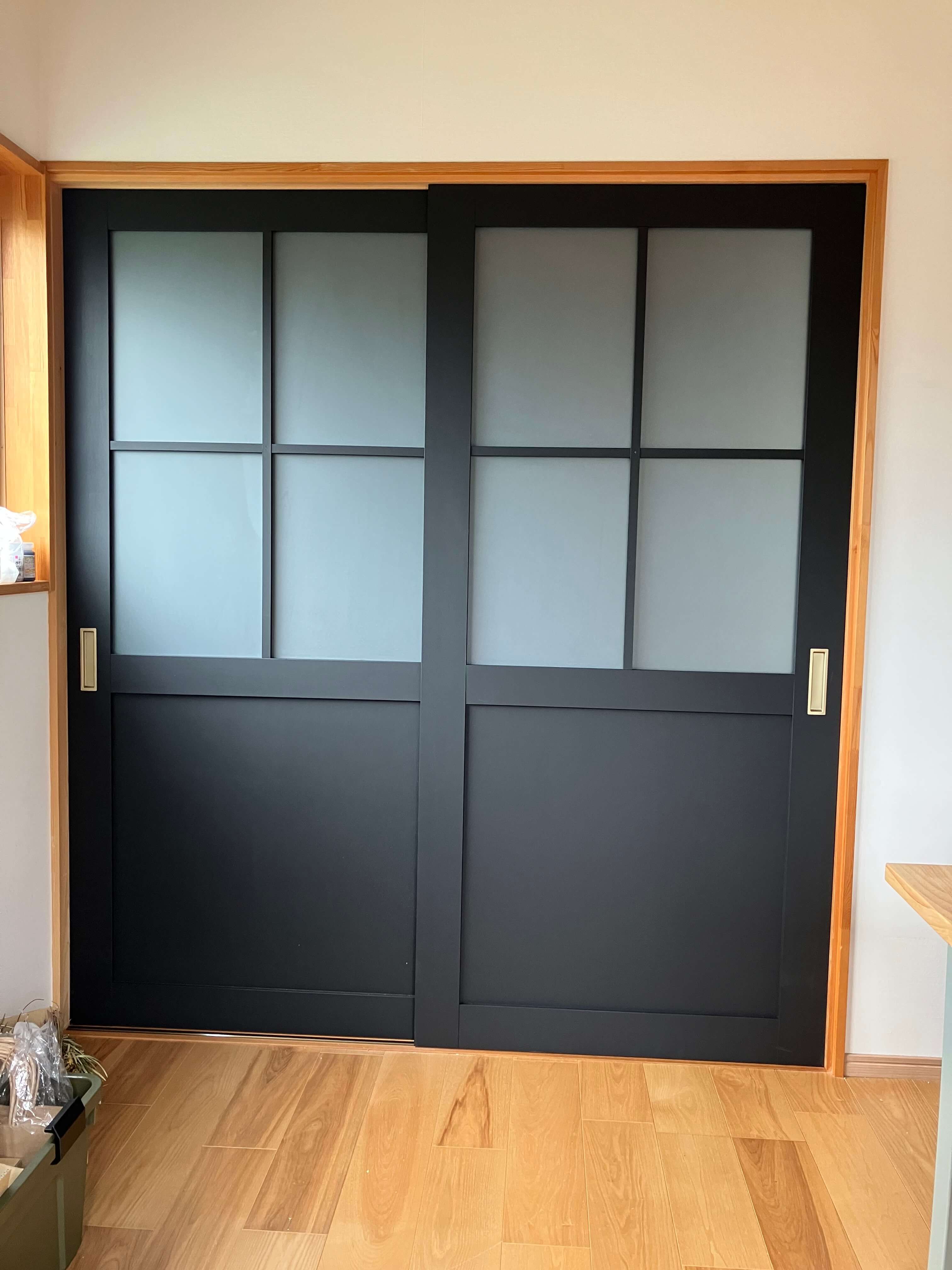 木目のタイルを貼る男性